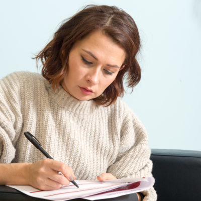 Woman reviewing complaints form as she fills it out